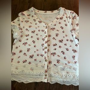 White and pink floral shirt, kind of a crop top